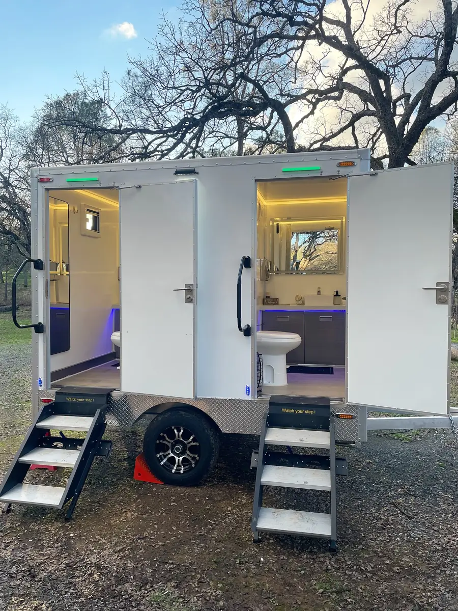 Two-room luxury restroom trailer with open doors and steps
